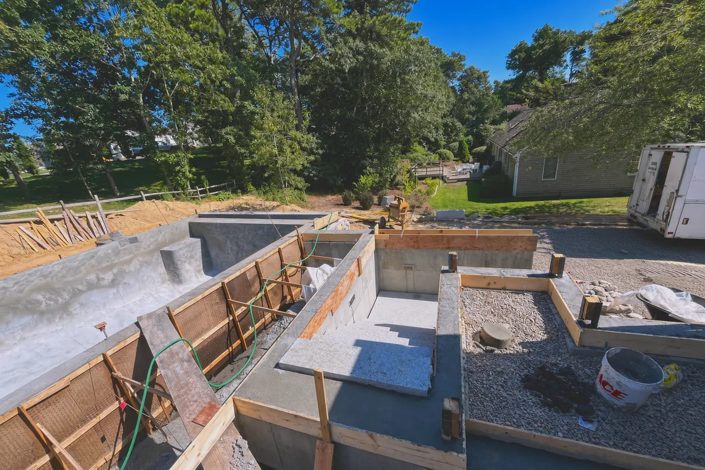 Formed concrete walls and footings for a pool terrace and steps